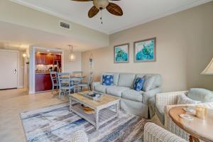 a living room with a couch and a table at 291 Sandcastles in Amelia Island