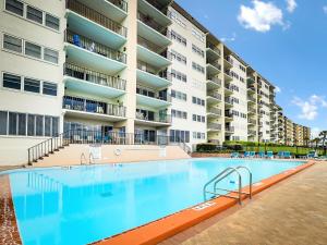 a large swimming pool in front of a apartment building at Amelia South C3 in Amelia Island