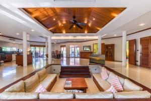 a living room with a couch and a ceiling fan at Amber Pool Villa Your private slice of paradise in Rawai Beach