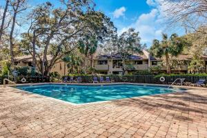 a swimming pool in front of a house at 3050 Club Villas in Amelia Island
