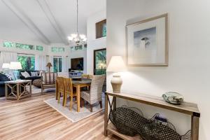 a dining room and living room with a table and chairs at 2349 Courtside Villas in Amelia Island