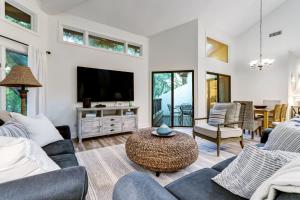 a living room with a couch and a tv at 2349 Courtside Villas in Amelia Island