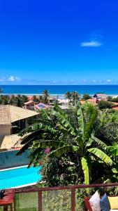 a view of the ocean from the balcony of a resort at Castelo Pink Boutique Hotel in Uruau