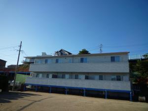 an apartment building with a roof on top of it at Seaside Hostel Light House - Vacation STAY 82336v in Onomichi