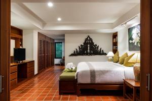 a bedroom with a large bed and a television at The Sands 2 bedroom apartment Naiharn in Nai Harn Beach +31 photos