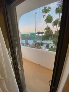 a room with a window with a view of a beach at Blife Sun Hostel in Faro