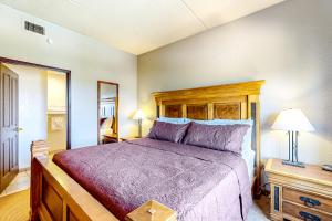 1 dormitorio con 1 cama grande y cabecero de madera en Chula Vista Condo, Unit 2344, en Wisconsin Dells
