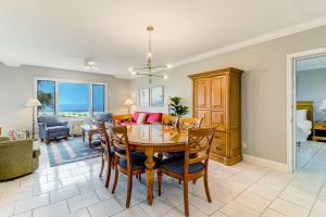 a dining room and living room with a table and chairs at 1817 Turtle Dunes in Amelia Island