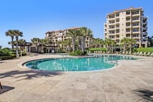 a swimming pool in front of a large apartment building at 1817 Turtle Dunes in Amelia Island