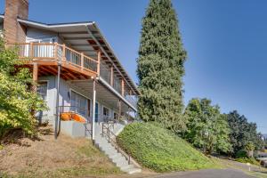 a house with a balcony and a tree at Chic Columbia City Vacation Rental with Kayaks! 
