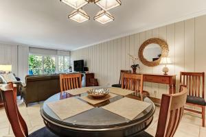 a living room with a table and a dining room at 2123 Beach Wood in Amelia Island