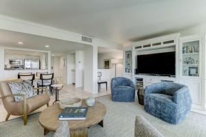 a living room with a couch and chairs and a tv at 1380 Shipwatch in Amelia Island