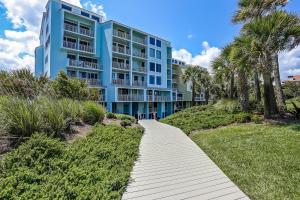 a walkway leading to a blue apartment building at 1380 Shipwatch in Amelia Island