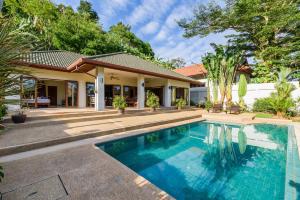 una imagen de una piscina frente a una casa en Aster Pool Villa, en Rawai Beach