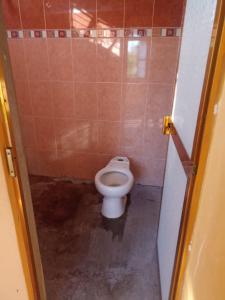 a small bathroom with a toilet in a stall at cuartos en renta El portón azul in Ixtepec