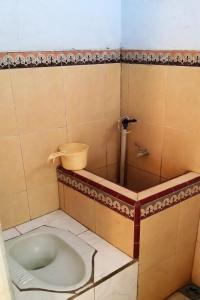 a bathroom with a toilet in a stall at SPOT ON 93014 Griya Nautika Sukodono in Sidoarjo