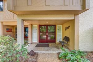 a house with a red door and a chair at 2091 Beach Wood in Amelia Island
