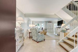 a living room with a staircase and a chair at 2091 Beach Wood in Amelia Island