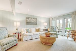a living room with a couch and two chairs at 2091 Beach Wood in Amelia Island