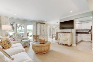 a living room with a white couch and a tv at 2091 Beach Wood in Amelia Island