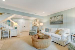 a living room with a white couch and a table at 2091 Beach Wood in Amelia Island +44 photos