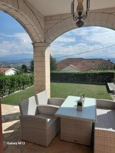 an outdoor patio with two chairs and a table at Ioannina Cozy Hill House in Pedini