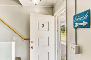 a white door in a room with a sign on the wall at 2810 Ohio Avenue #3 in Amelia Island