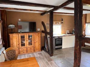 a kitchen with wooden cabinets and a stove top oven at Wohnen auf dem Bauernhof in Herdecke
