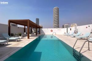 a swimming pool on the roof of a building at bnbmehomes - Modern Luxury Studio in heart of JVC - 419 in Dubai