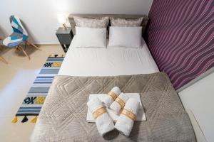 a hotel room with two beds with towels on them at Central & Riverfront Room in Edessa