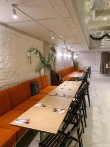 a row of tables and chairs in a restaurant at Apart Hotel Avinos in Lviv