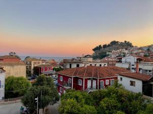 a group of houses in a city at sunset at Hotel Galini in Parga