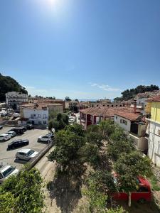 a city with cars parked in a parking lot at Hotel Galini in Parga