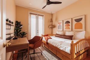 Luxe Boho Retreat Near Torrey Pines - Sleeps 10 في سان دييغو: غرفة نوم بسرير ومكتب وكرسي