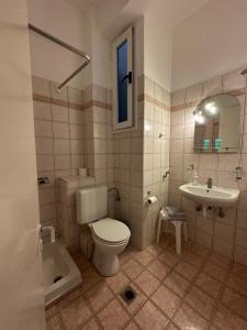 a bathroom with a toilet and a sink at Hotel Galini in Parga