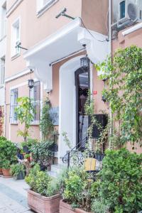 an entrance to a pink building with potted plants at Bayer Hotel in Istanbul