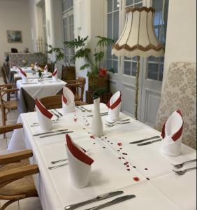 a white table with red and white dishes on it at Gemütliche 1 Zimmerwohnung in Sankt Radegund bei Graz