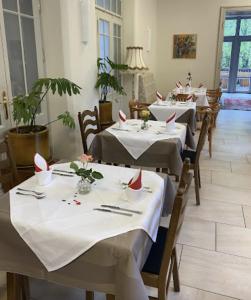 a row of tables in a restaurant with white table cloth at Gemütliche 1 Zimmerwohnung in Sankt Radegund bei Graz