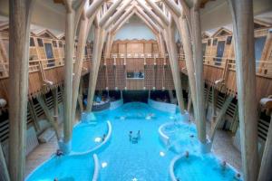 a large indoor swimming pool with people in it at Appartement Lafayette N°3 in Bagnères-de-Bigorre