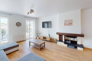 a living room with a couch and a table at Appartement Lafayette N°3 in Bagnères-de-Bigorre