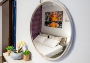 a living room with a couch and a mirror at Central & Riverfront Room 1 in Edessa