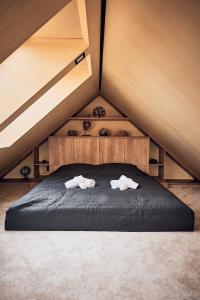 a bed in a room with two towels on it at Chata Scheelit in Banská Štiavnica