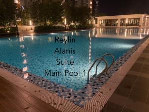 ein Schwimmbad in der Nacht mit den Worten "Review Alms Suite" Hauptpool in der Unterkunft Reylin Alanis Suite // Free Wifi & Netflix // Airport Shuttle Service in Sepang