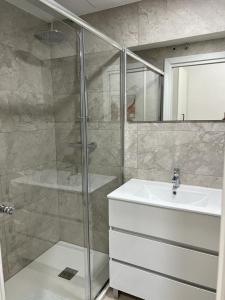 a bathroom with a shower and a sink at aparment la Elipa in Madrid