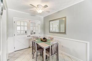 a dining room with a table and chairs and a mirror at 2810 Ohio Avenue #4 in Amelia Island