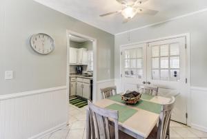 a dining room with a table and a clock on the wall at 2810 Ohio Avenue #4 in Amelia Island