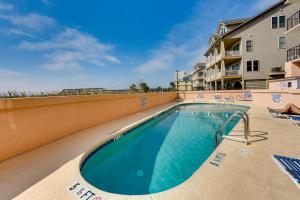 a swimming pool at a resort with chairs and a building at Pool Access 8th-Floor Condo on North Myrtle Beach in Myrtle Beach