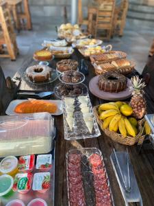 um buffet com muitos tipos diferentes de sobremesas e frutas em Ribeiro Suit's Hotel em Araxá