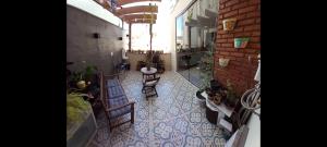 a view of a room with chairs and a table at Apartamento Le Quartier - no centro, dois quartos, wi-fi, garagem, piscina, ar-condicionado, jacuzzi, sauna, etc in Juiz de Fora