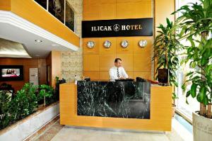a man sitting at a desk in a lobby at Ilıcak Hotel in Istanbul